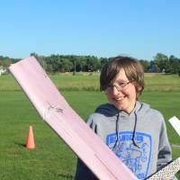 Student poses with his plane